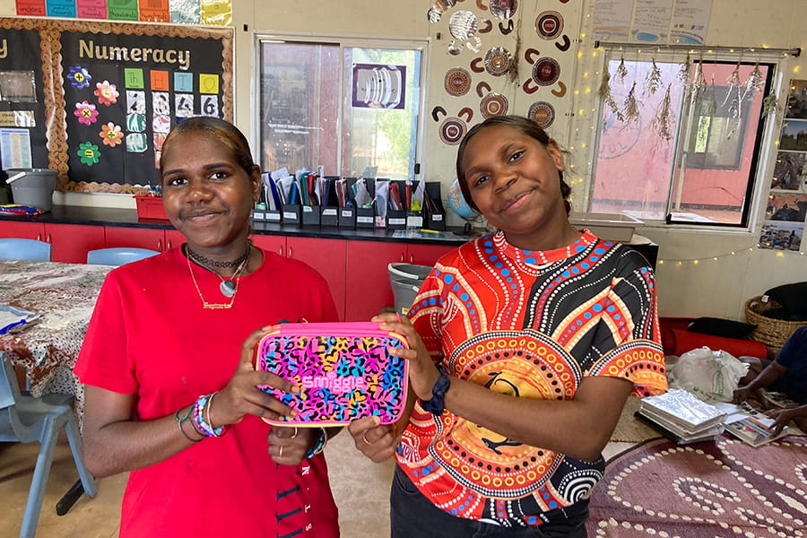 women-holding-school-supplies-give-write-charity-wa