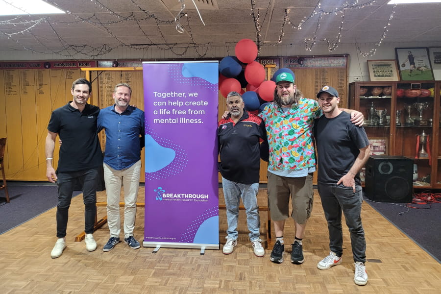 men-in-hall-with-banner-breakthrough