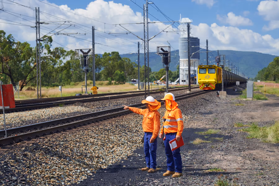 aurizon-workers-near-rail-line-with-locomotive