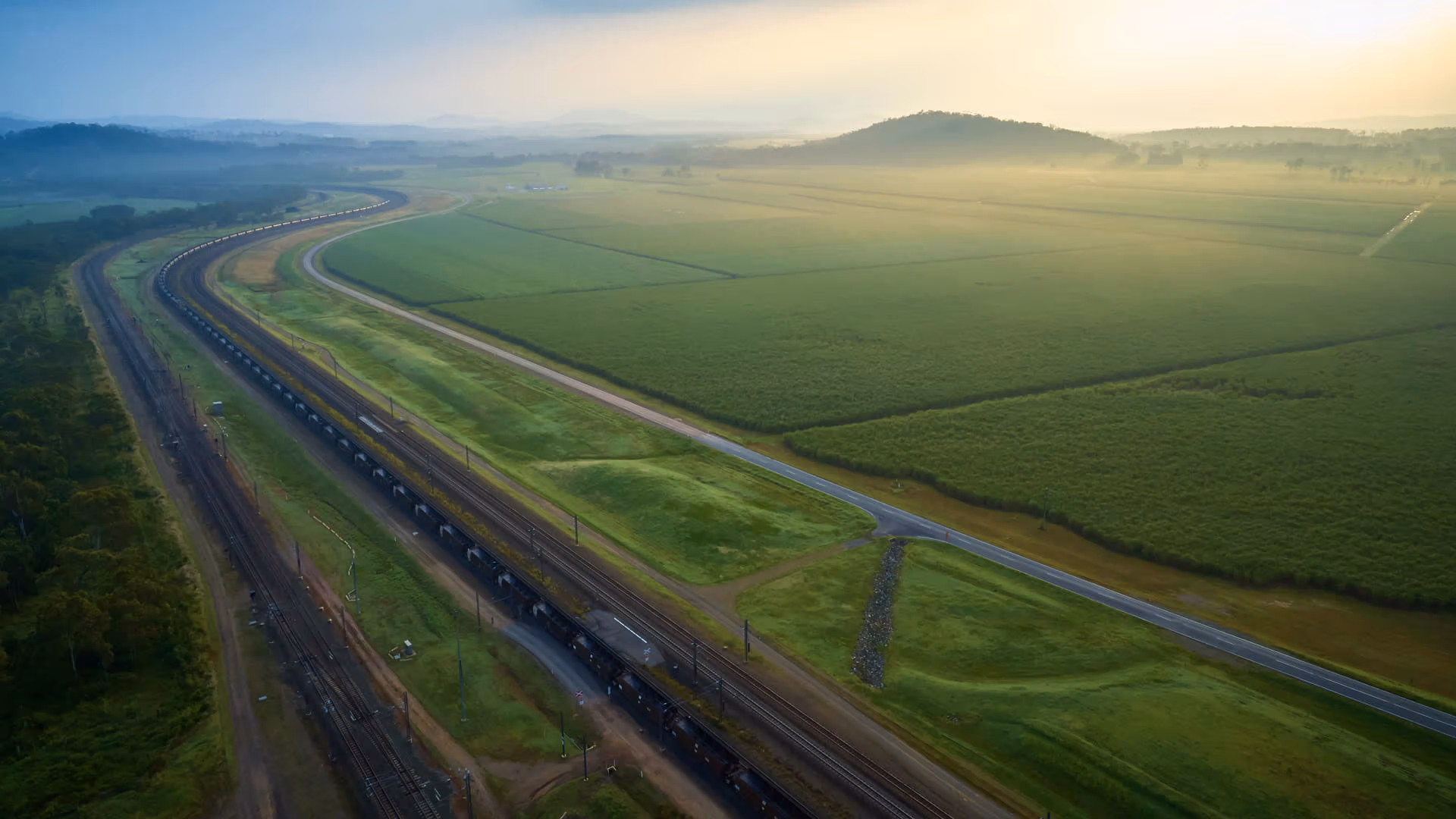 coal-train-moving-through-green-fields-cqcn-header-banner